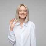 women wearing white long sleeved collared shirt holding bitcoin