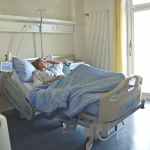 photo of woman lying in hospital bed