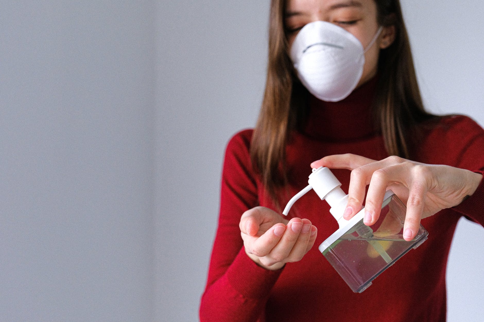 woman applying hand sanitizer