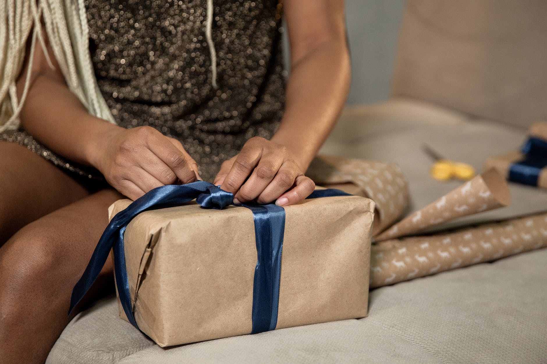 close up shot of a person wrapping a gift box
