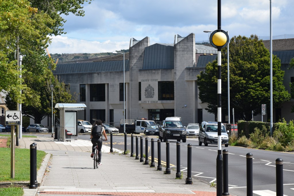 Man cycling towards Swansea Crown Court