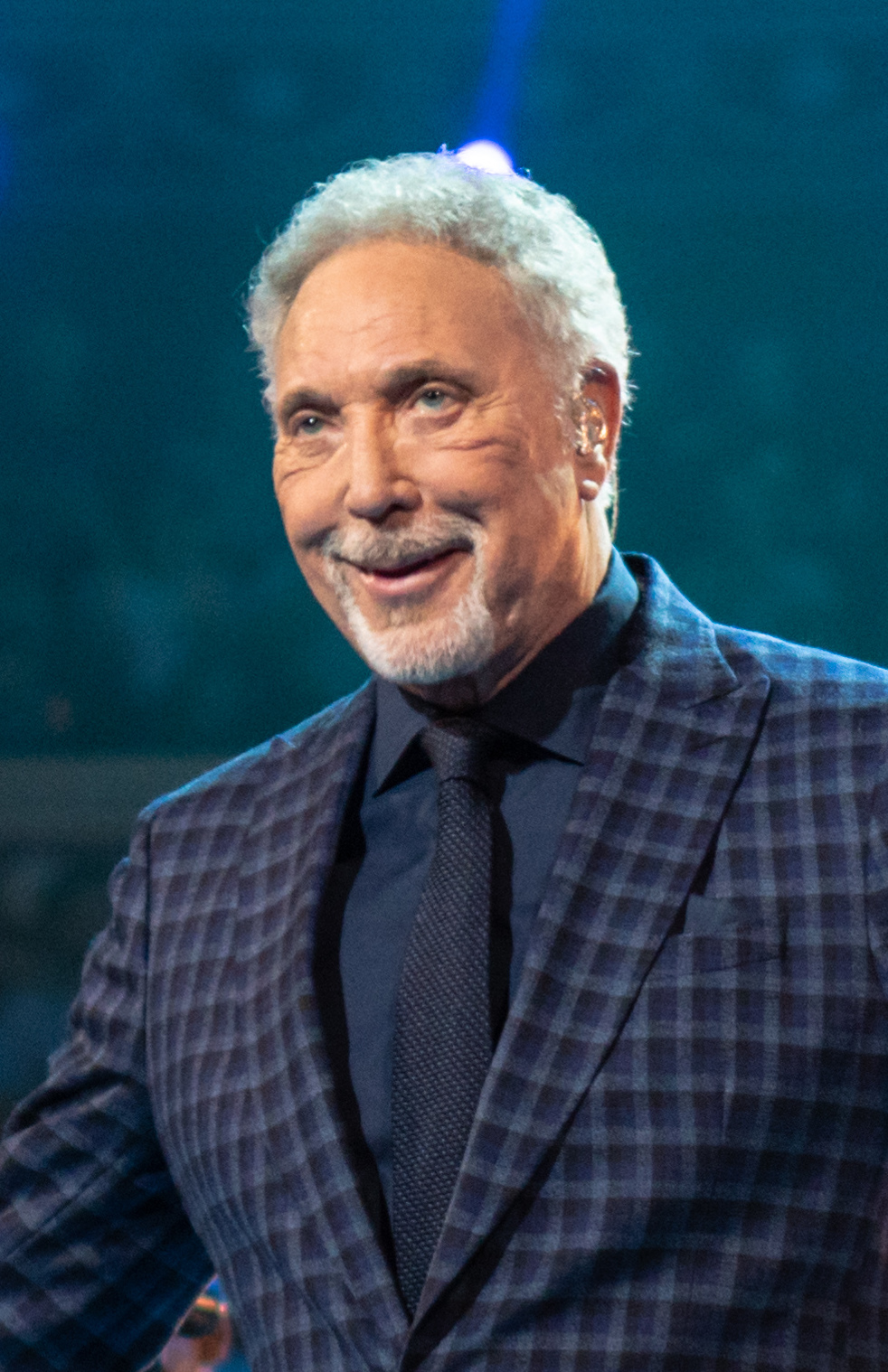 Sir Tom Jones smiling in a dark suit