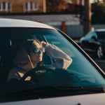 photograph of a woman with sunglasses waiting in a car