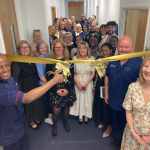 Richard Desir, Nursing Officer for Wales, cuts the ribbon to officially open the Nurse Education Training Suite.