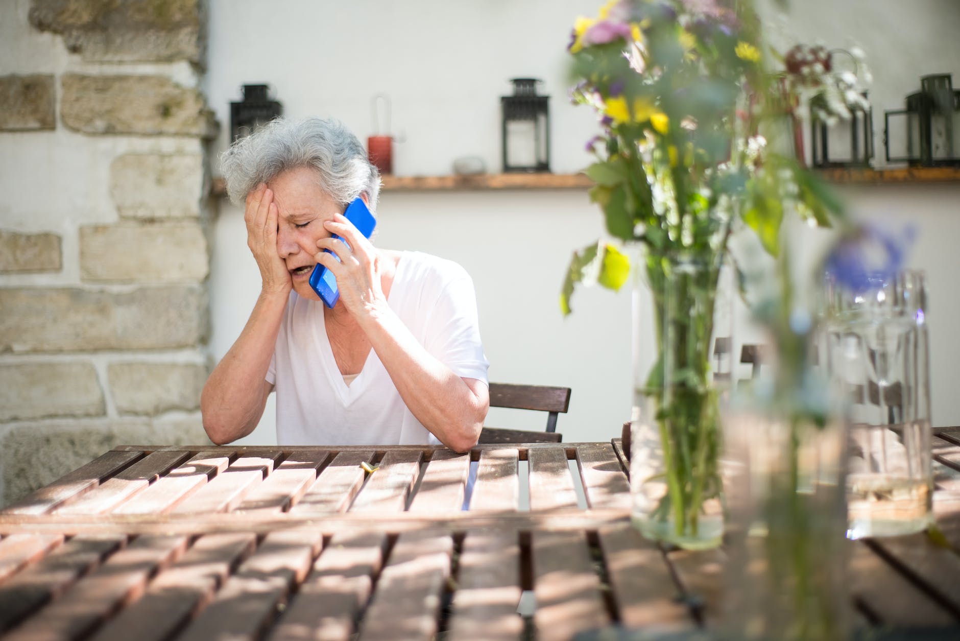 elderly woman crying while on phone call