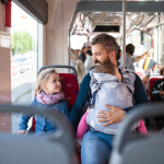 Man and family riding a bus