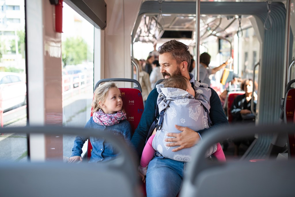 Man and family riding a bus