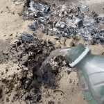 BBQ coals on beach