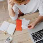 woman sitting behind the desk and looking at receipts