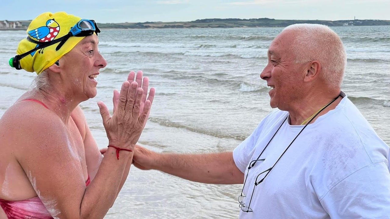 Makala being met by Patrice Chassery. He meets every successful swimmer who lands on Wissant beach in France (Image: Jemeima Phillips-Richardson)