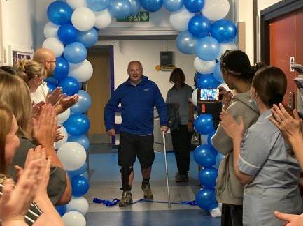 Alan crossed the finish line at the entrance to Ward F.