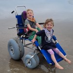 Sebastian and his sister in a multi-terrain buggy on the beach.