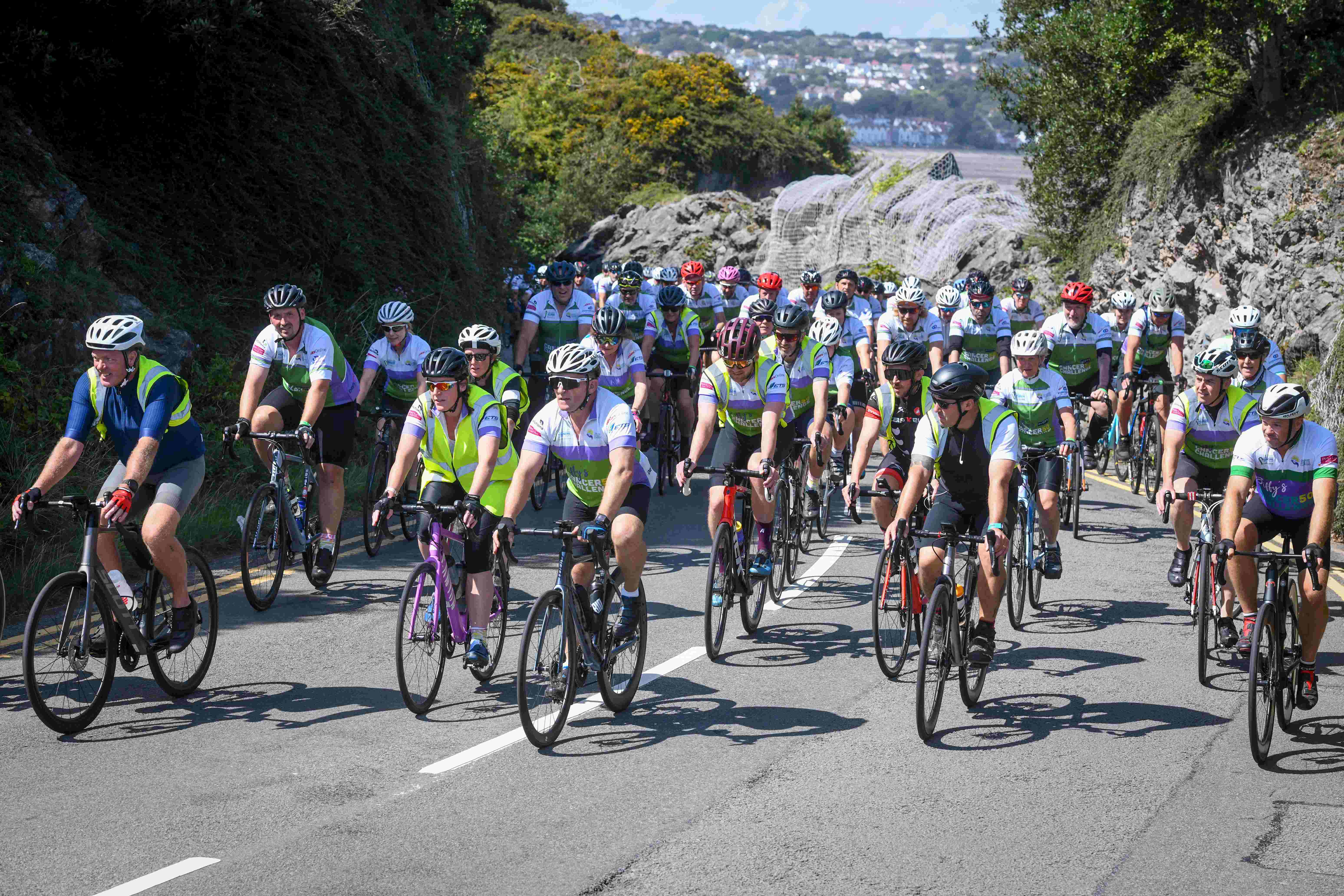 Some of the 600 riders ascend the hill leading towards the finish line in Bracelet Bay.