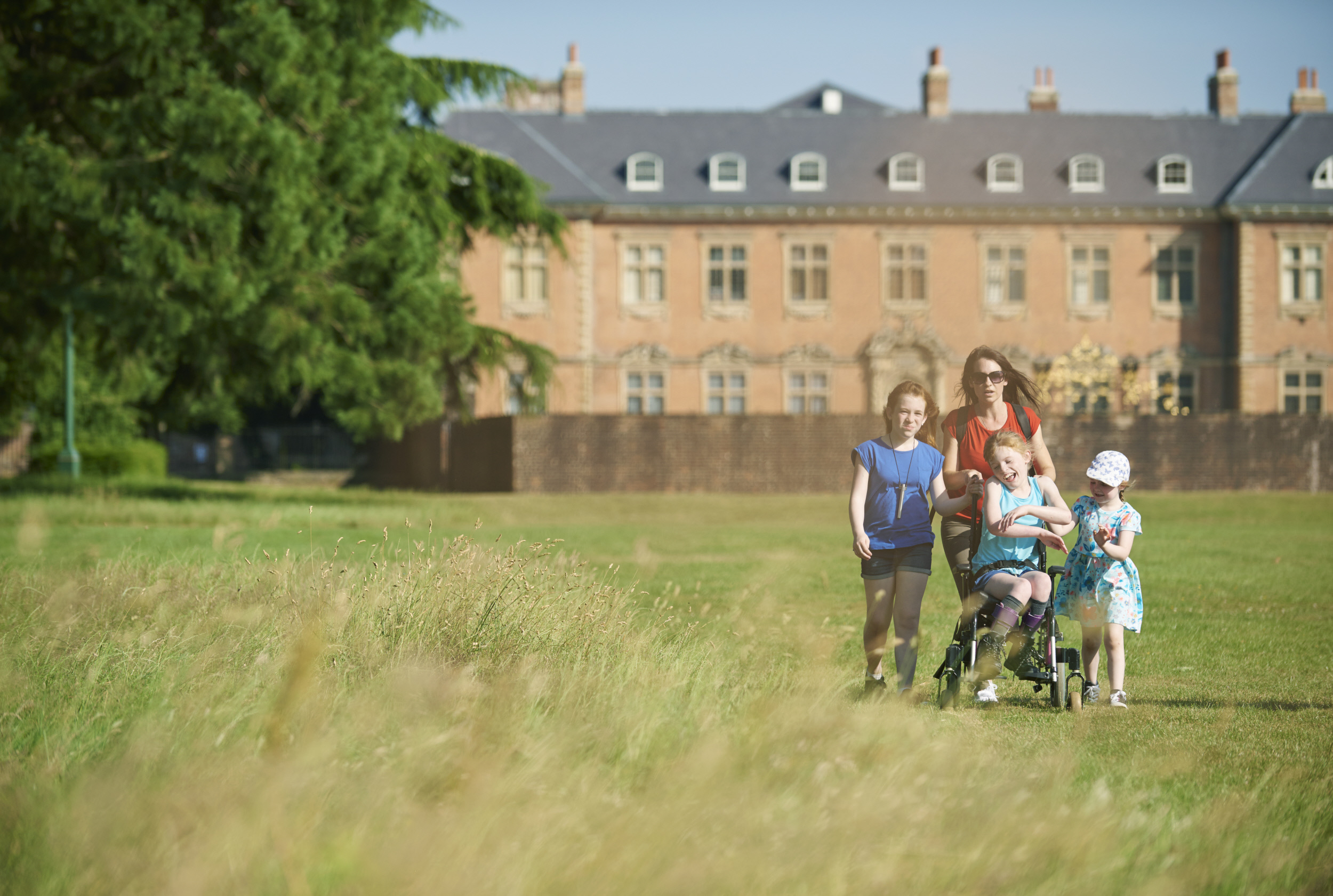 Visitors exploring the parkland at Tredegar House, Wales