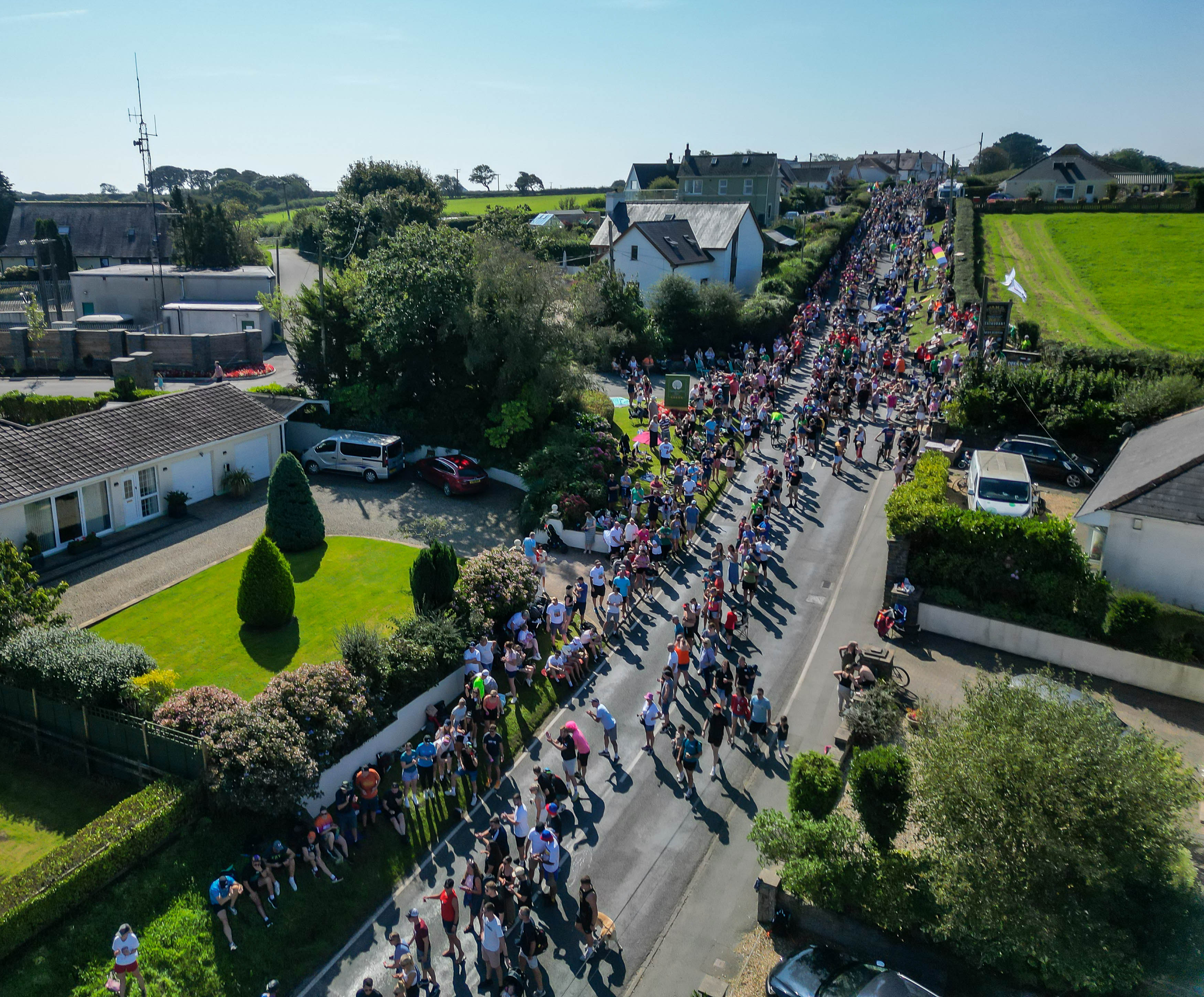 Crowds line the streets to support the IRONMAN athletes as they cycle through Pembrokeshire's stunning countryside.