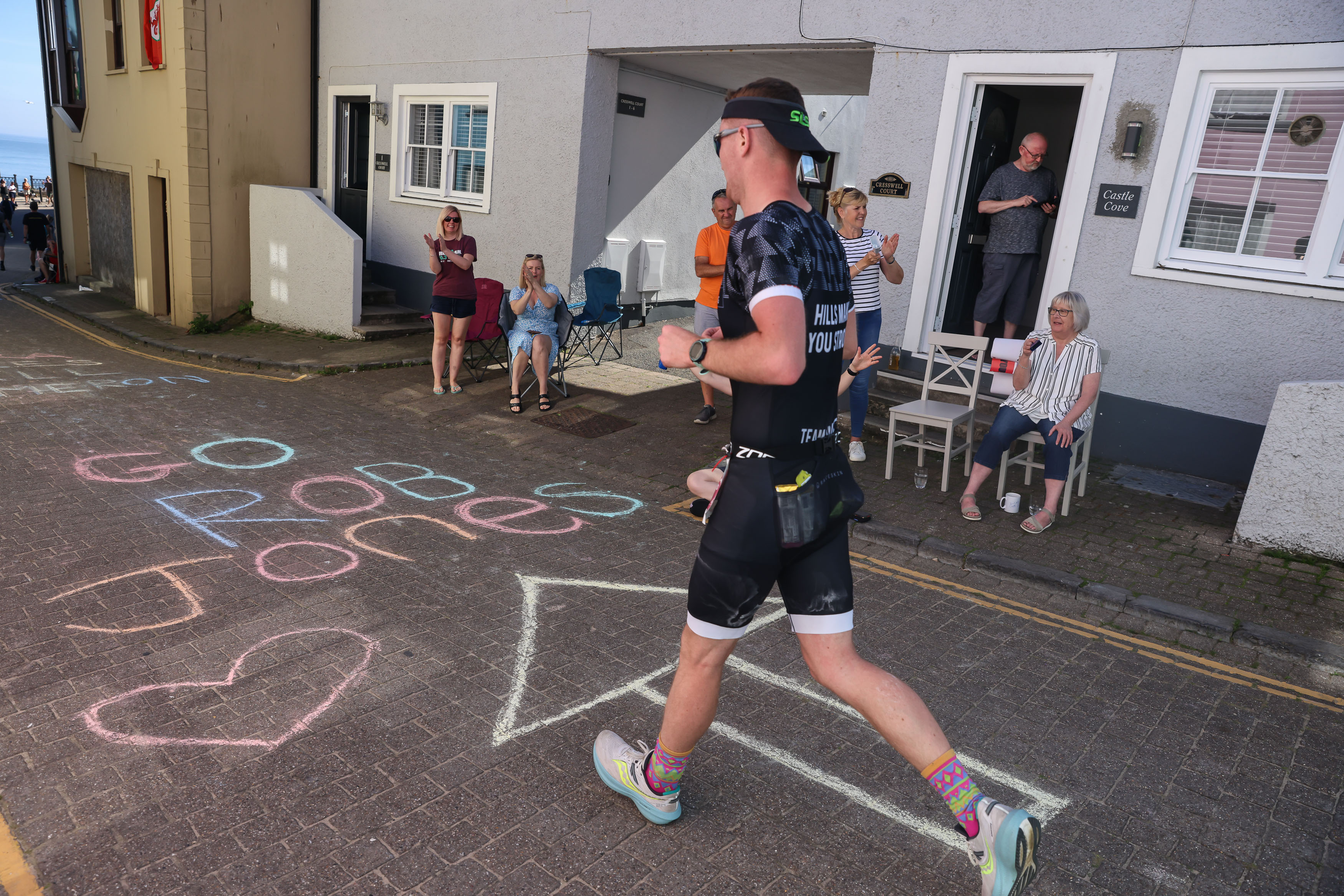 Supporters cheer the runners as they make their way through Tenby's streets