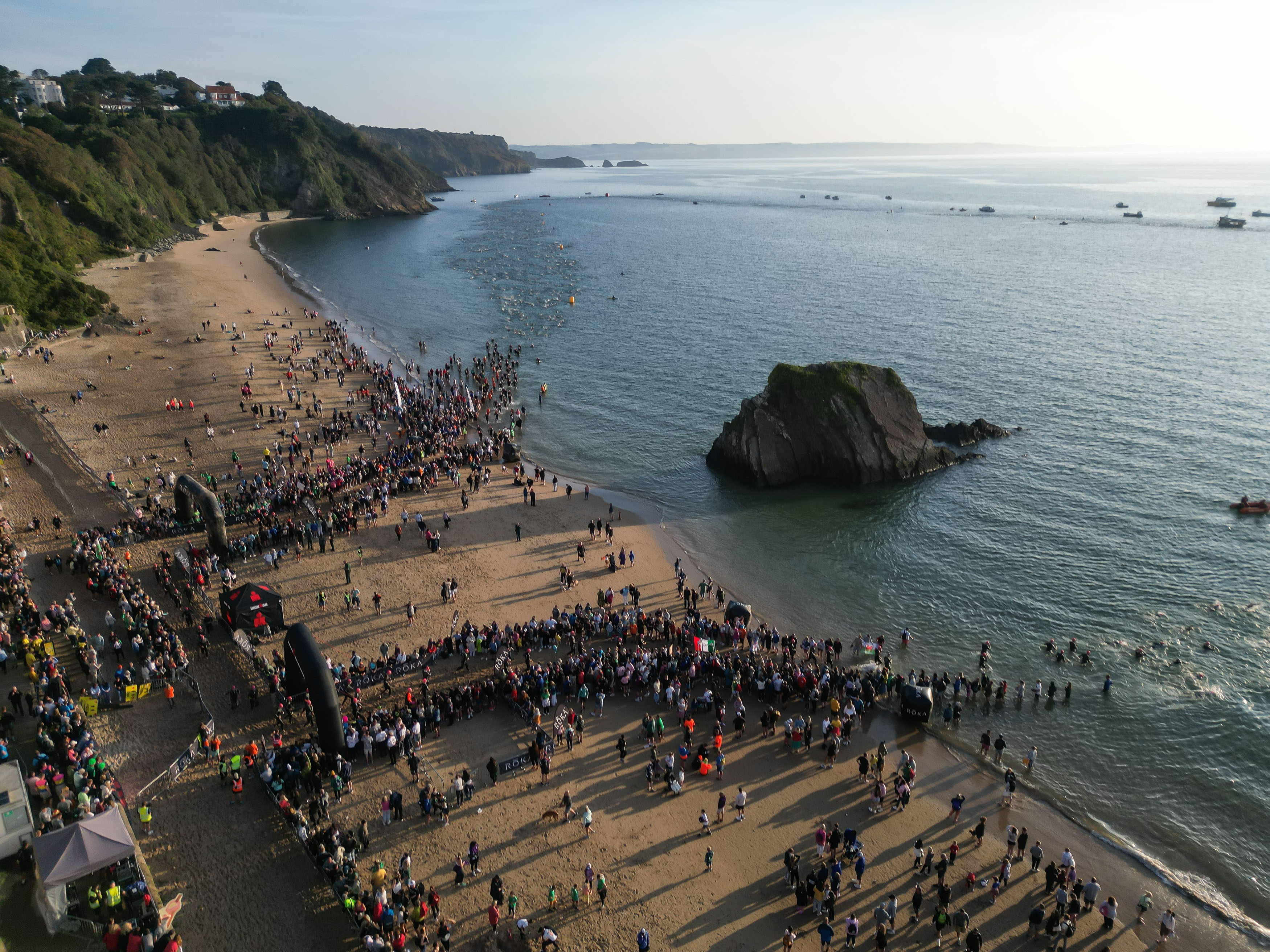 Swimmers enter the water at Tenby for the first stage of IRONMAN WALES