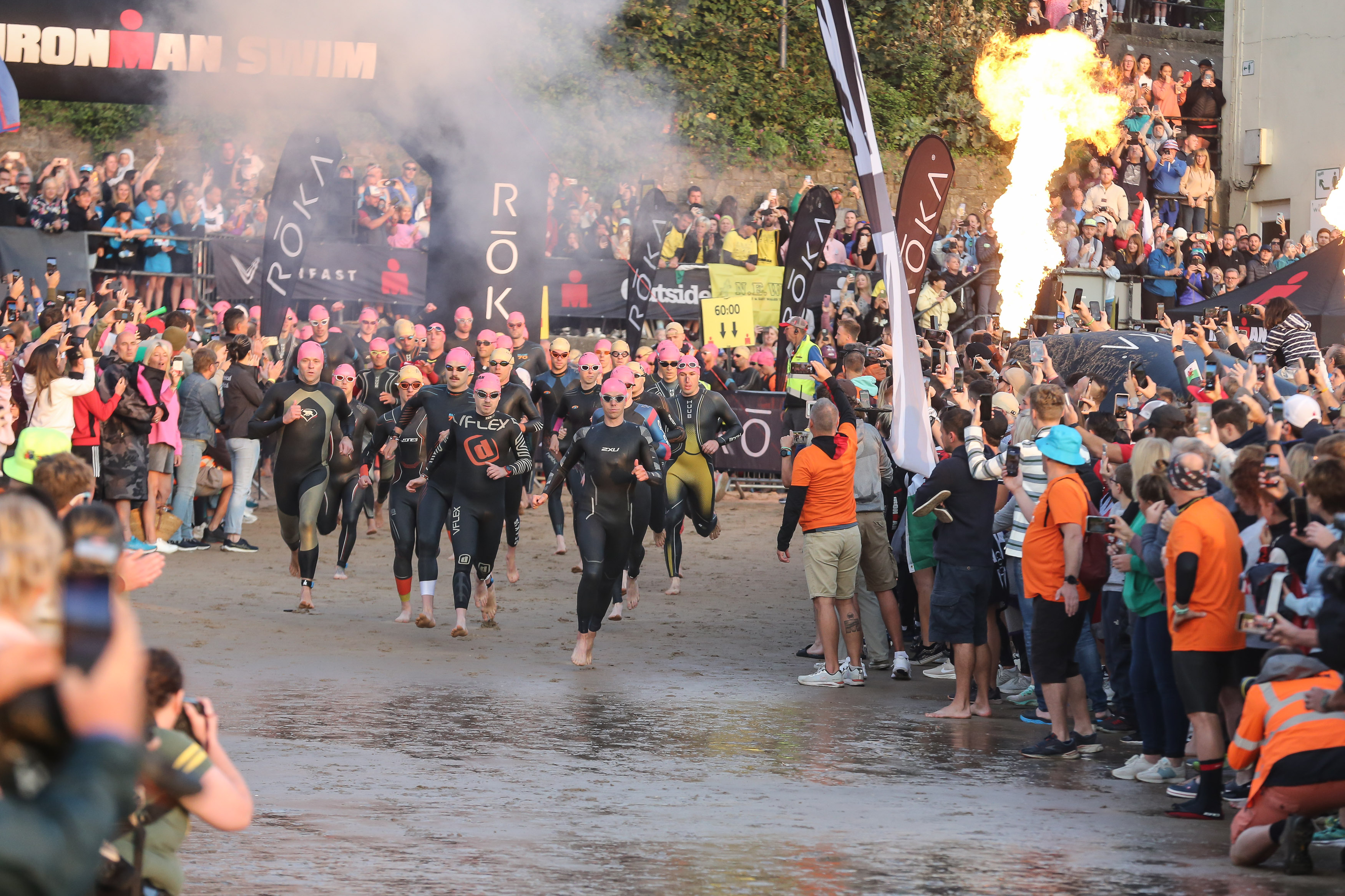 IRONMAN Swimmers racing towards the water.