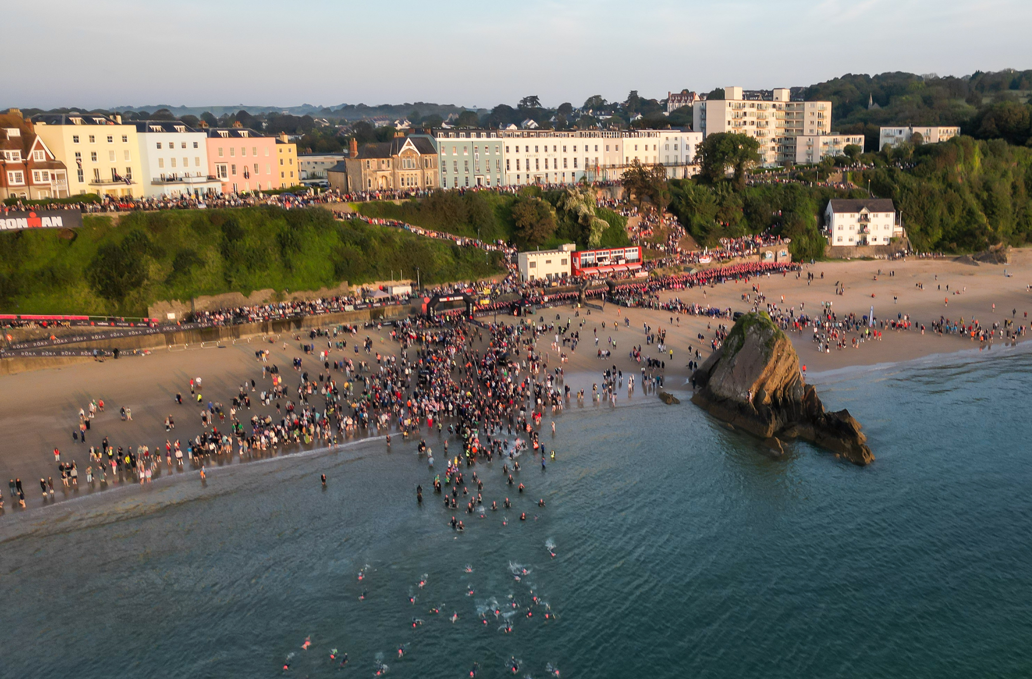 Swimmers enter the water at Tenby for the first stage of IRONMAN WALES (Image: Huw Fairclough for IRONMAN UK)