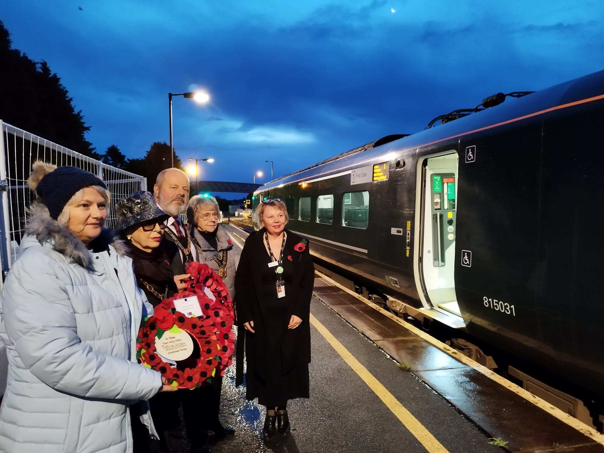 The Mayor of Llanelli, Cllr Nick Pearce along with other dignitaries get ready to place their poppies onto the train at Llanelli train station early this morning.