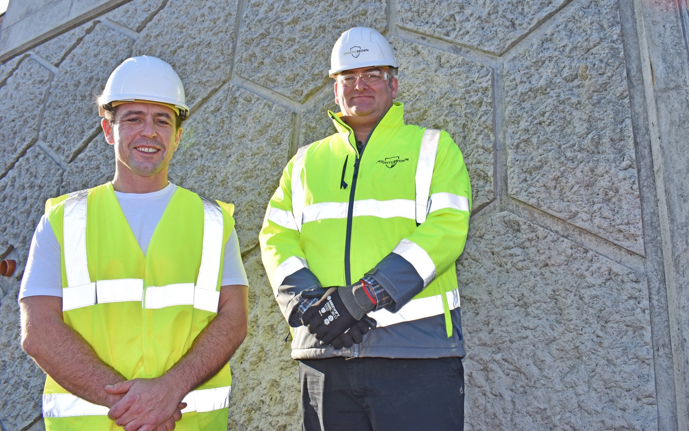 Council cabinet member Andrew Stevens, left, at a new section of textured Mumbles sea wall with Tim Waller, divisional manager of main contractor Knights Brown.