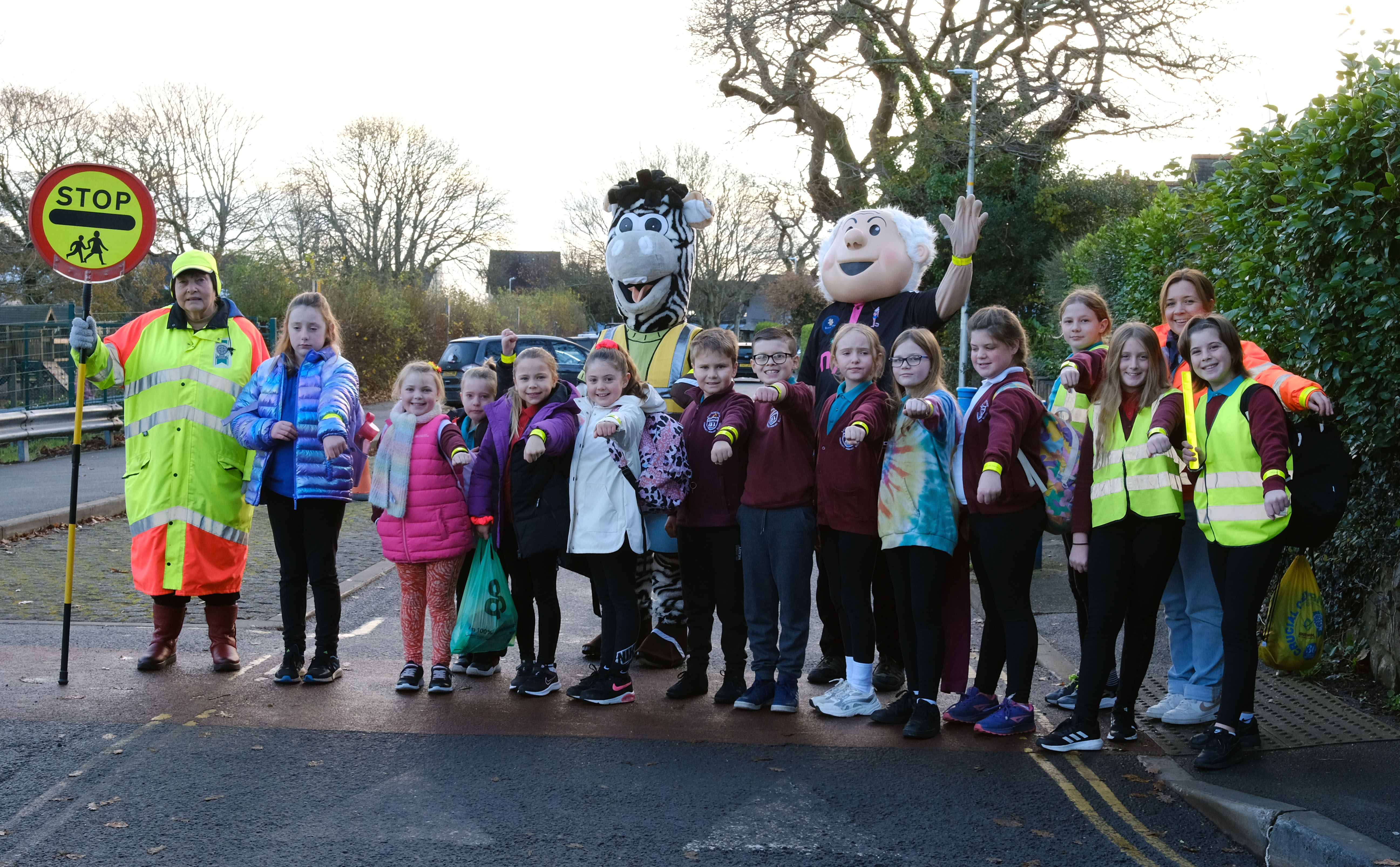 Saundersfoot CP School pupils are pictured on the Stride to School wearing their slapbands, sponsored by South Hook LNG, with school crossing patrol officer Sylvia Price and Helen Luff from the Council’s road safety team.