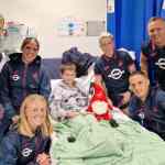 Riley Jenkins, 10, was visited by Swansea City players (back row, from left) Harry Darling, Jess Williams, Stacey John-Davis and club ambassador Lee Trundle along with Sophie Brisland-Hancocks and Jerry Yates. (Image: Swansea Bay NHS)