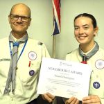 Student Niamh Dorrington receiving her Neighbourly Award certificate from Scout Leader Ben Ball.