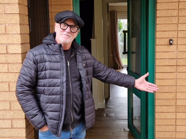 Mal Pope pictured outside one of the homes