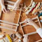 top view photo of two person s hands weaving