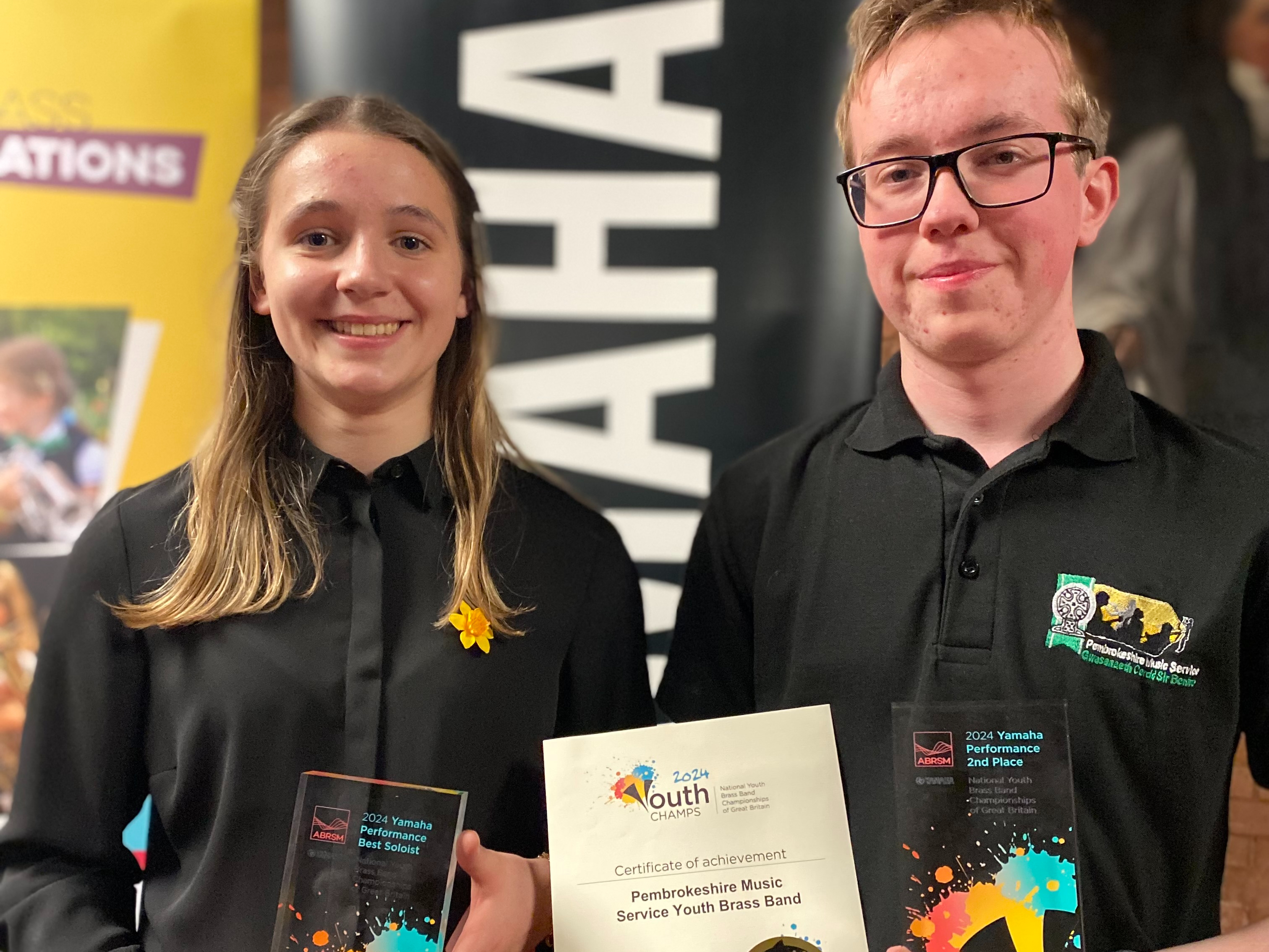 Best soloist recipient Carys and Brass Band member Filip collecting the awards