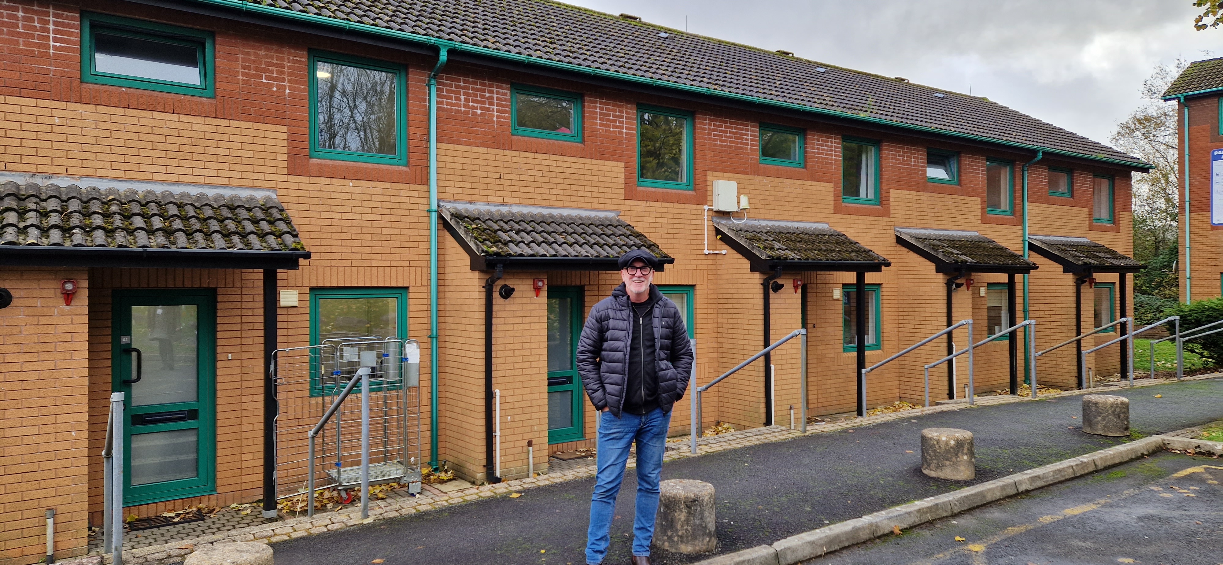 Musician and radio presenter Mal Pope outside one of the properties