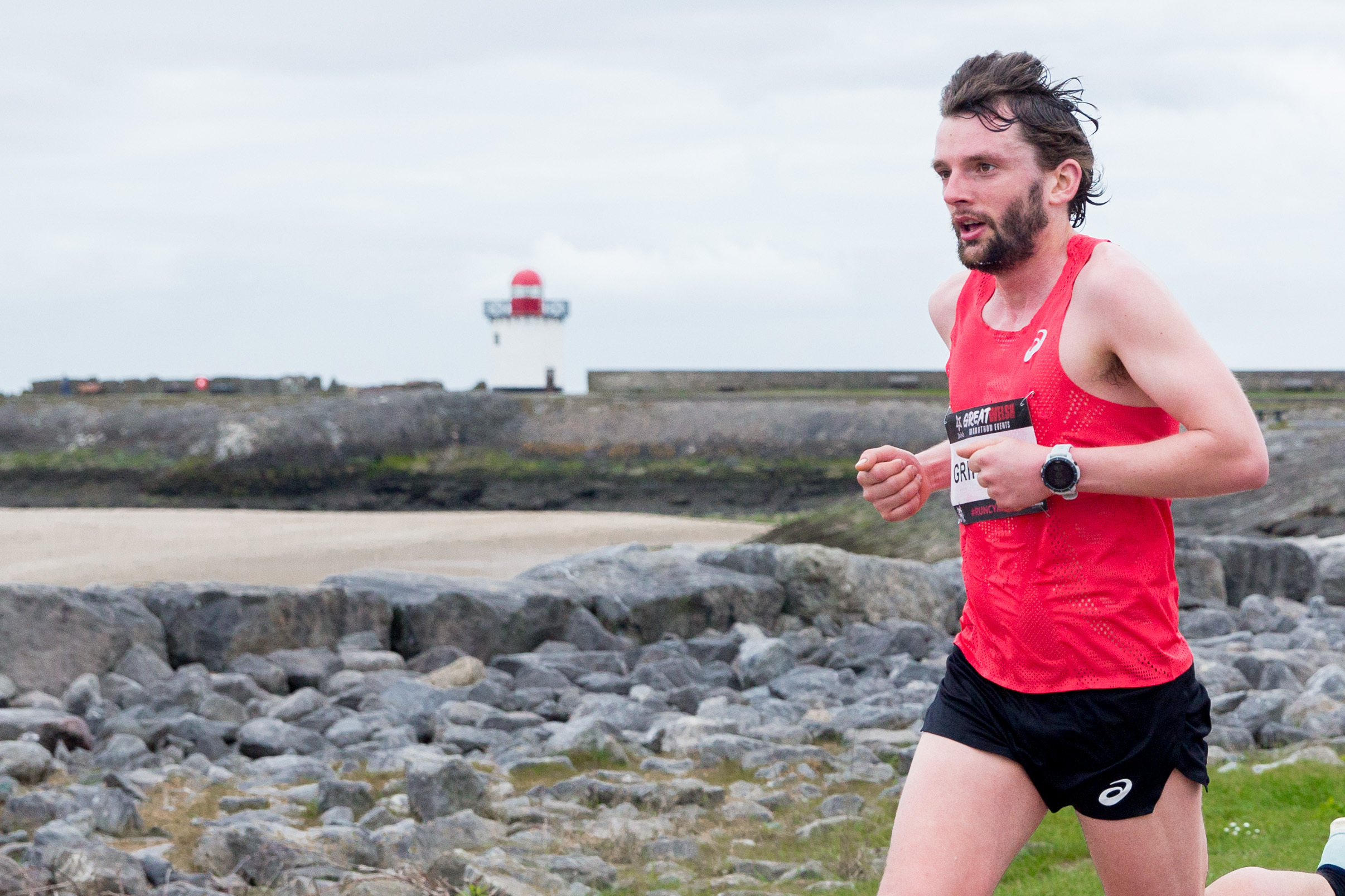 Dewi running past Burry Port Lighthouse in last year's event