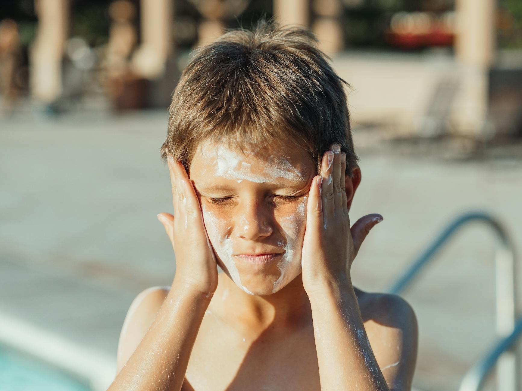 a boy with sunscreen on his face