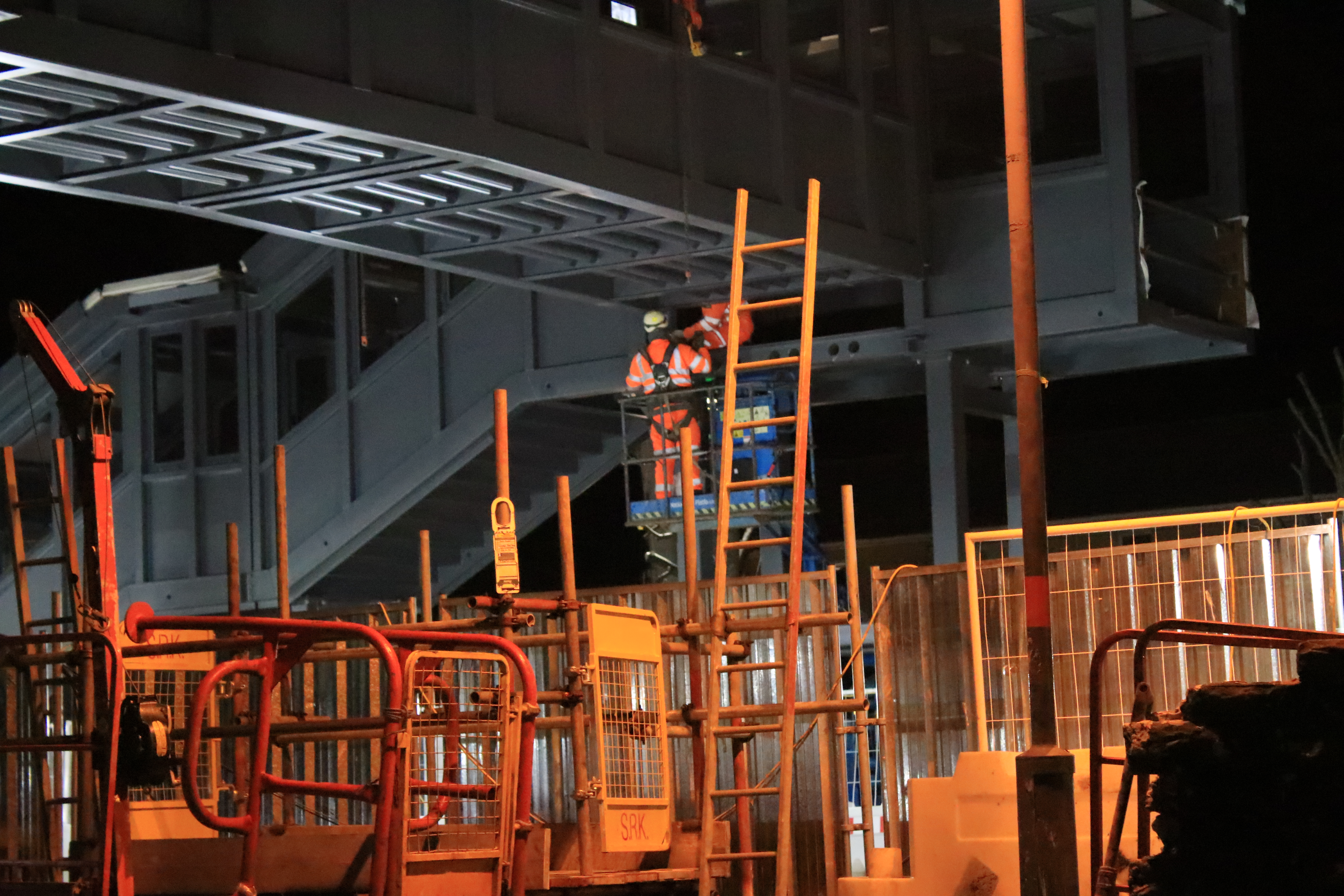 Contractor from AmcoGiffen works on the installation of the bridge span at Llanelli station