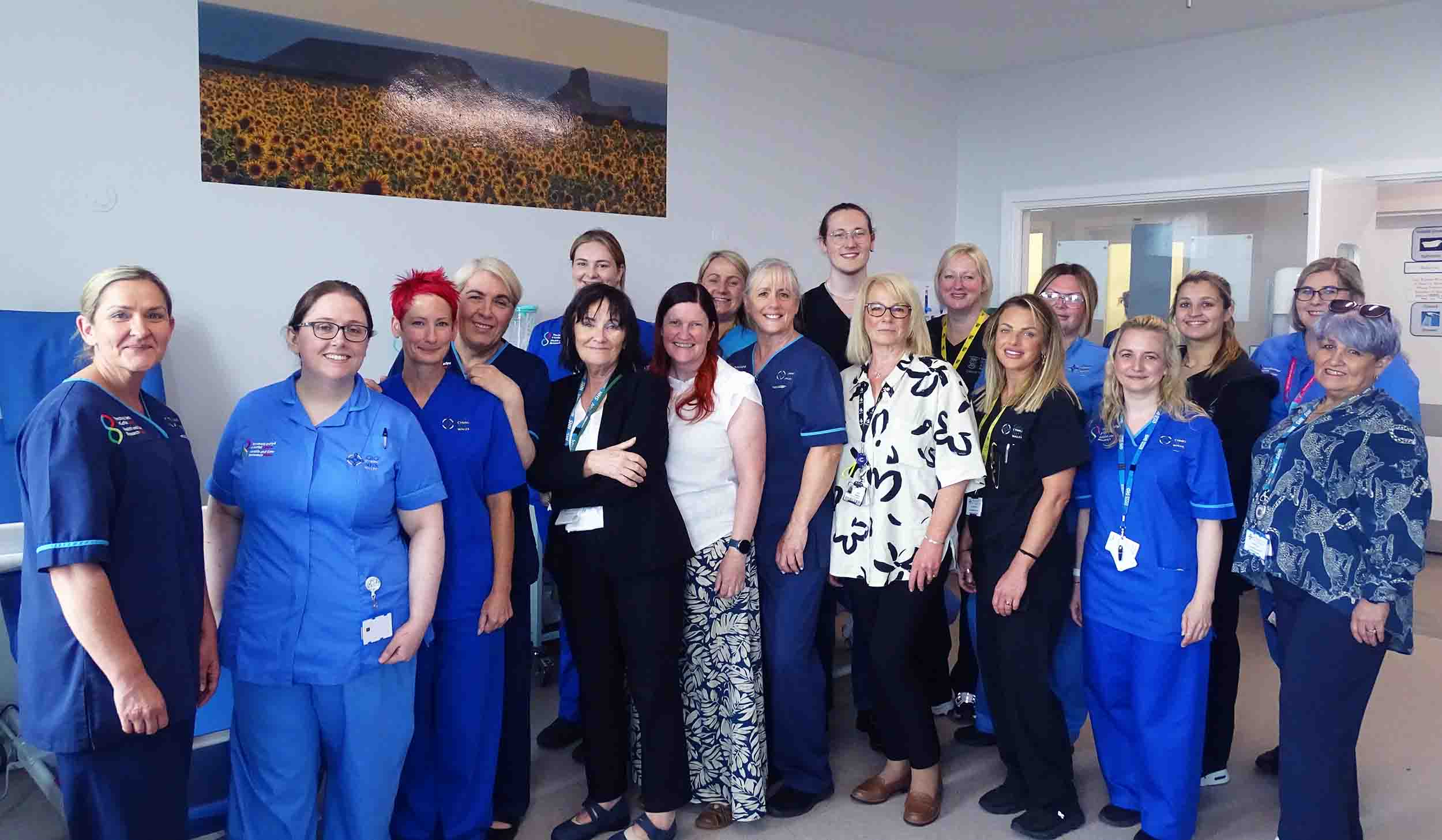 Research team members in one of the two rooms – both of which feature donated artwork.