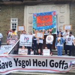 Parents and campaigners holding Save Ysgol Heol Goffa banners during a protest outside Carmarthenshire County Hall.