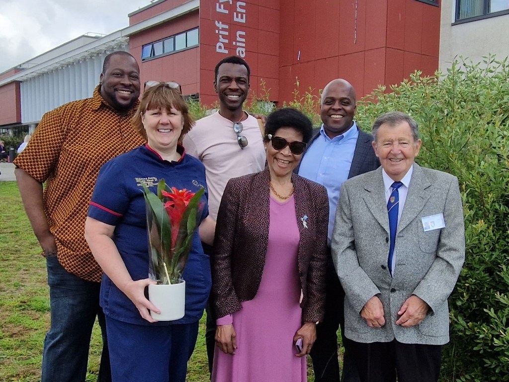 Agnes and her family are met by Rebecca Davies and League of Friends chairman John Hughes)