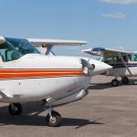 Light planes parked on the private airfield in summer