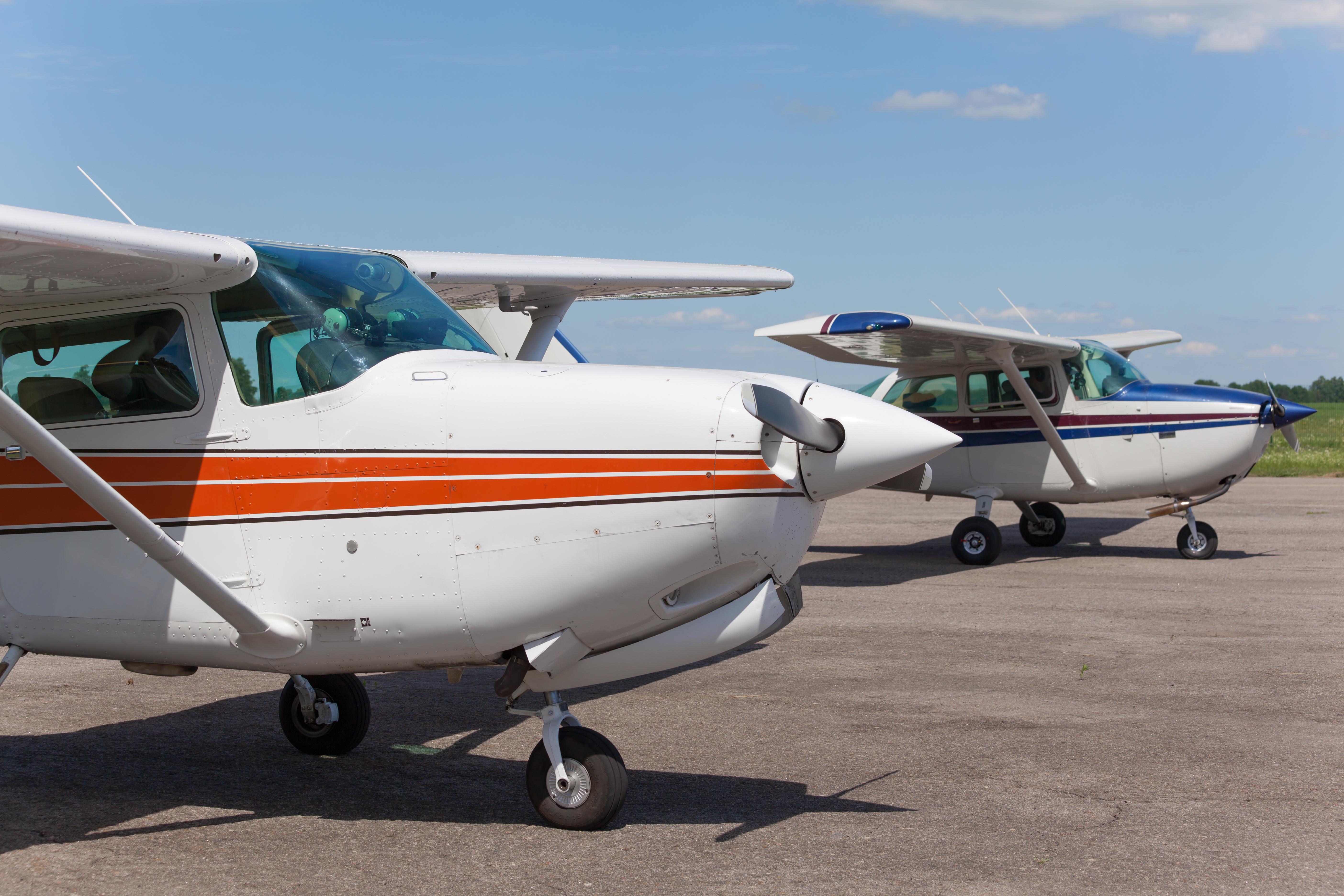 Light planes parked on the private airfield in summer