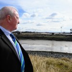 Council leader Steve Hunt stands on a hillside overlooking Port Talbot Steelworks in the distance, symbolising the community’s transition after the closure of the blast furnaces.