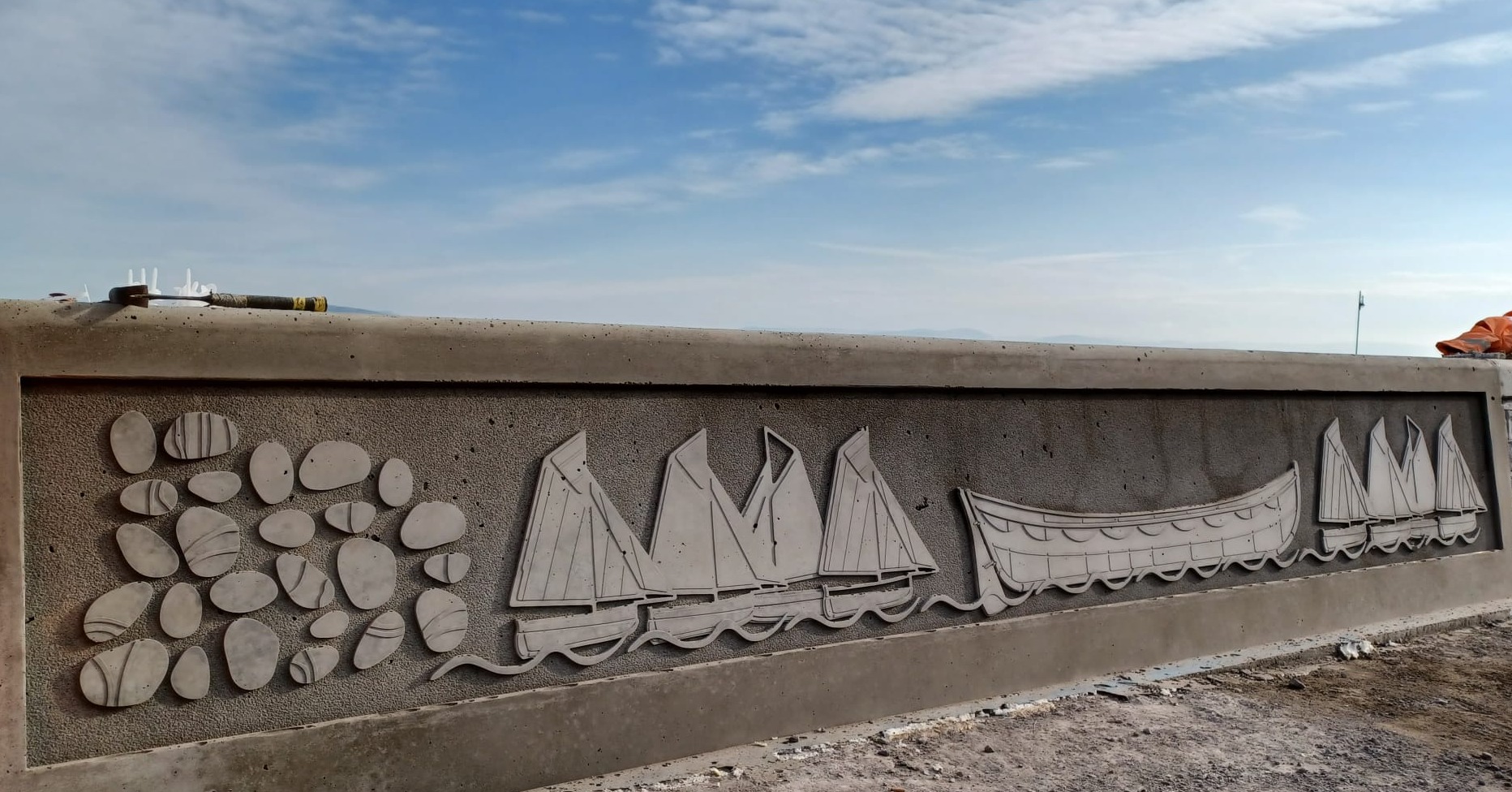 Artist, Catrin Jones' latest designs on the Mumbles sea defences include pebbles, oyster boats and a lifeboat.