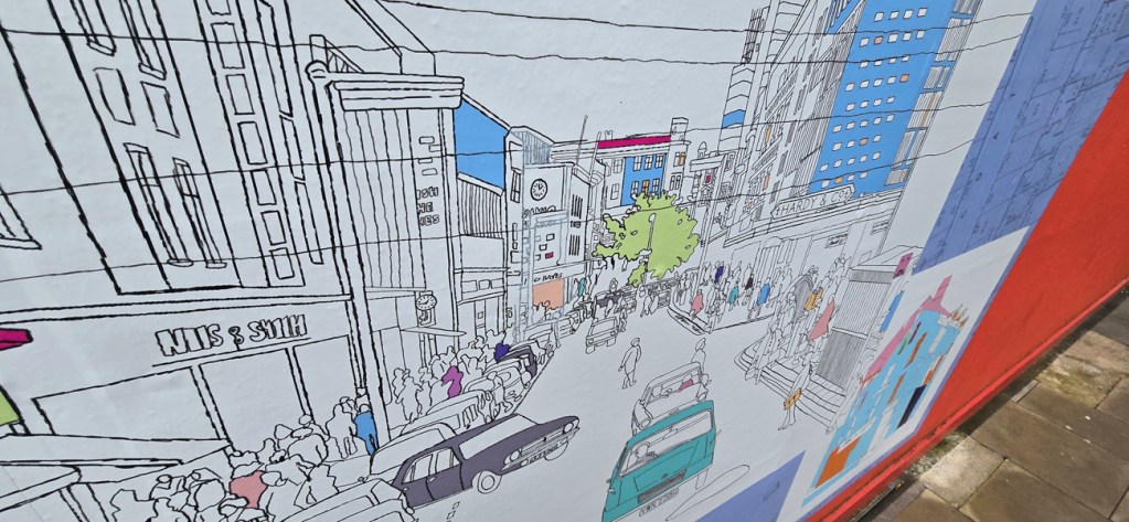 Examples of new public artworks installed on safety hoardings outside Swansea city centre’s emerging new community services hub Y Storfa. Pic: Swansea Council