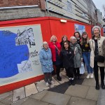 Members of community groups by some of their new work outside Swansea city centre’s emerging new community services hub Y Storfa. Pic: Swansea Council