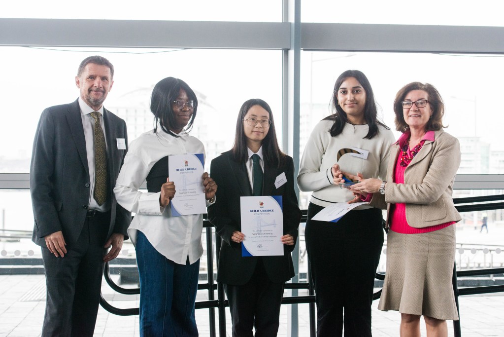 BCSA CEO Jonathan Clemens with students Esther Ijeli, Charlotte Chow and Soumya Singh receiving their award from First Minister Eluned Morgan (Image: Swansea University)