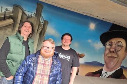Swansea Council cabinet member Elliott King at the city’s new Amy Dillwyn mural with Ronny Oner and Ryan Lewis, of Oner Signs. Pic Swansea Council
