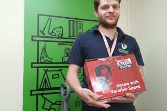 Adam, a beneficiary of Emmaus South Wales, holding a jigsaw — just one example of the many items available to borrow at a nominal fee from the newly launched