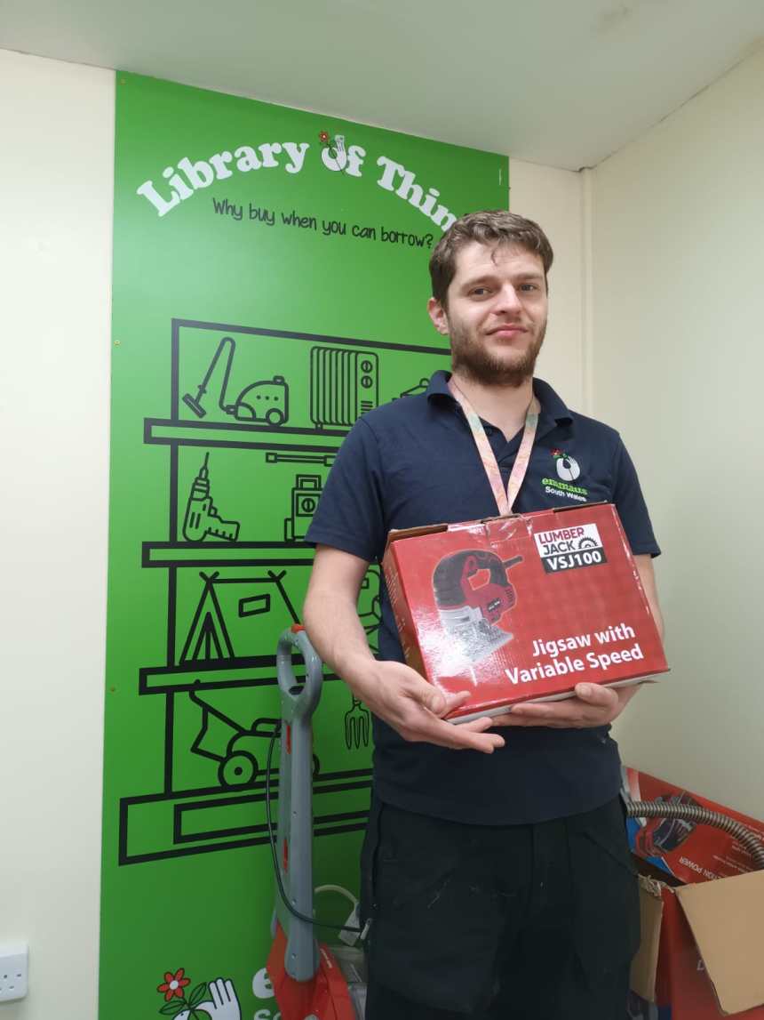 Adam, a beneficiary of Emmaus South Wales, holding a jigsaw — just one example of the many items available to borrow at a nominal fee from the newly launched