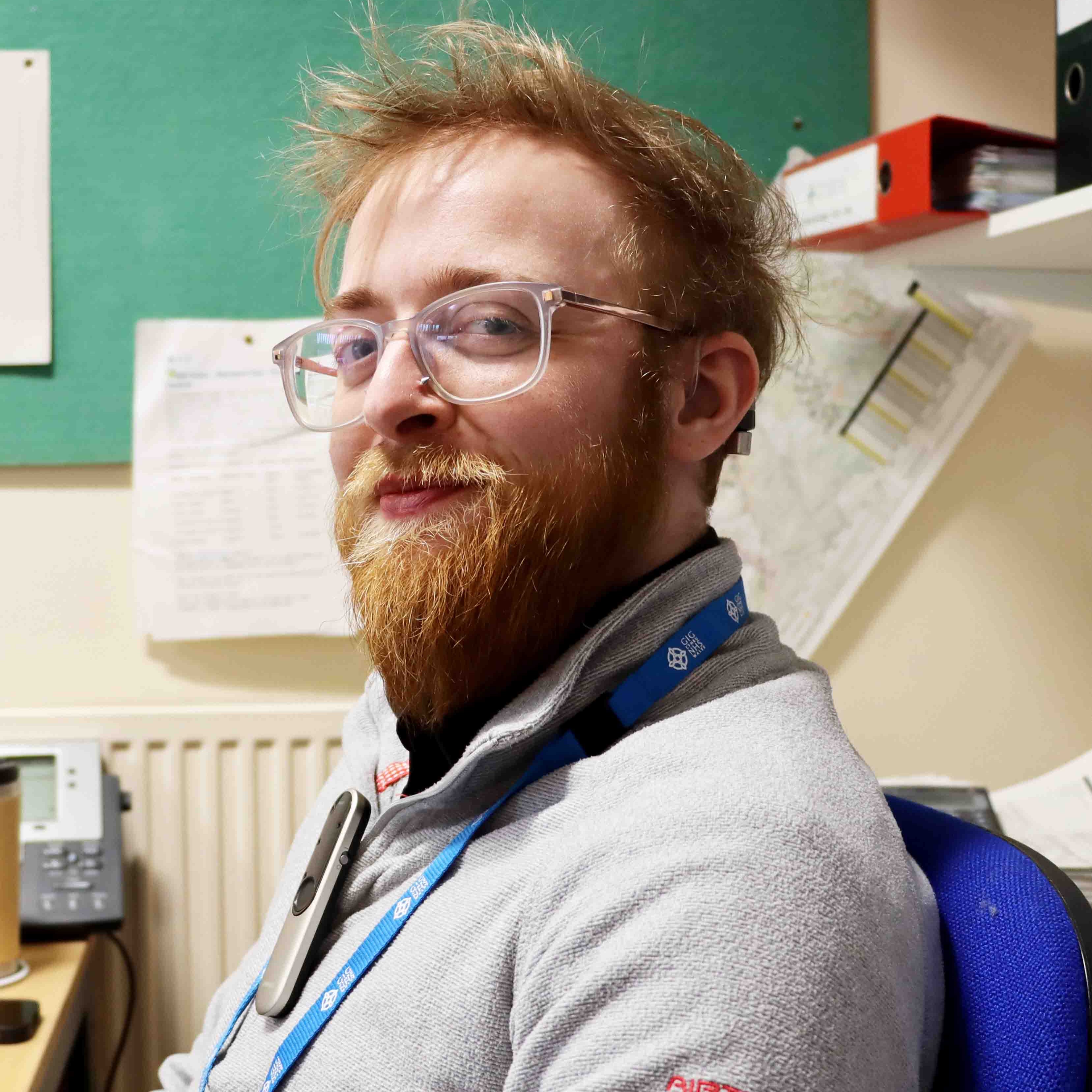 Aeron wearing the microphone attached to his jumper. This transmits directly to his hearing aids.