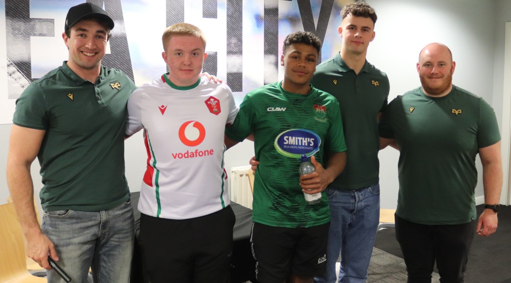 Young people supported by Action for Children Mackenzie and McKenzi with Ospreys stars Luke Scully, Connor Moyse and Rhys Henry